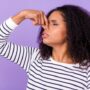 Profile side photo of unhappy woman wavy hair cover nose feel bad smell stink isolated on violet color background