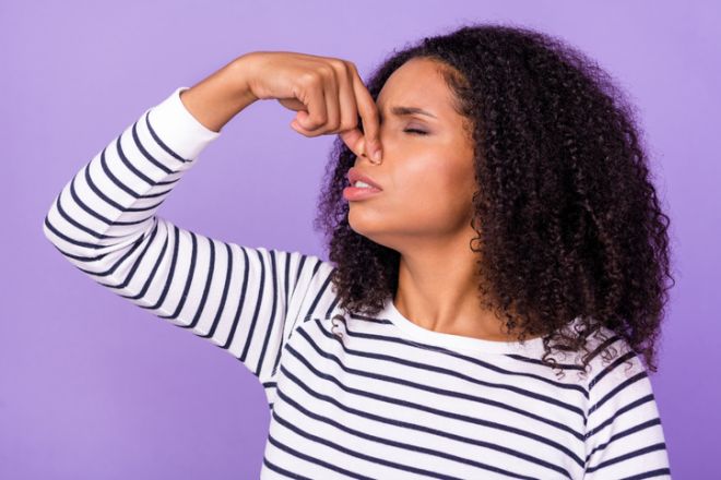 Profile side photo of unhappy woman wavy hair cover nose feel bad smell stink isolated on violet color background
